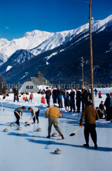 Curlingspieler und Zuschauer auf Eisfeld