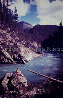 Frau auf Felsen beim Inn