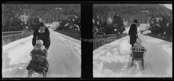Frau mit Kind unterwegs mit dem Schlitten, Winter