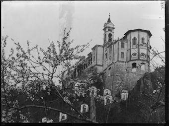 Madonna del Sasso mit Kreuzwegkapellen, blühender Ast im Vordergrund