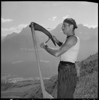 Mann am Schärfen der Sichel