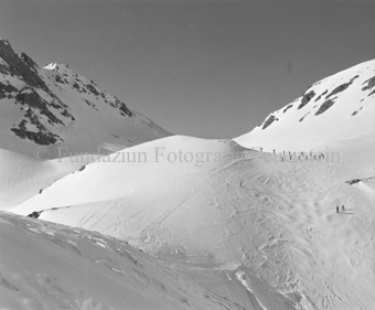Skifahrerkolonne in den Bergen