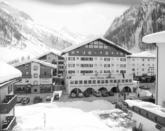 Dorfansicht mit Hotel «Silvretta», parkierte Autos auf der Strasse