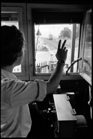 Bahnwärter winkt einfahrendem Zug