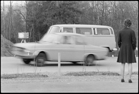 VW-Bus neben Radarkasten, vorbeifahrendes Auto