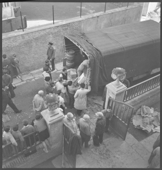 Ankunft der Lastwagen, mit Lebensmitteln, vor der Schweizerschule