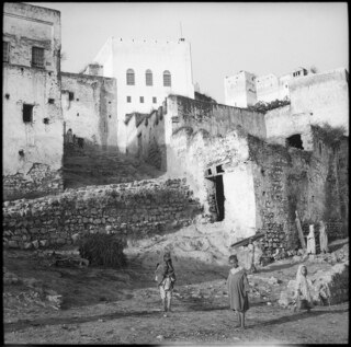 Französisch-Marokko, Moulay Idriss: Dorfansicht; Blick auf mehrere Häuser von Moulay Idriss an den Hang gebaut mit Kindern im Vordergrund