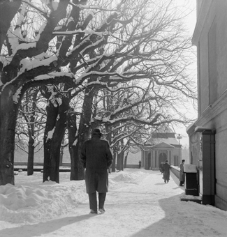 Spaziergänger auf der verschneiten Münsterplattform. Pavillon West, Kandelaber, rechts eine Personen- Waage