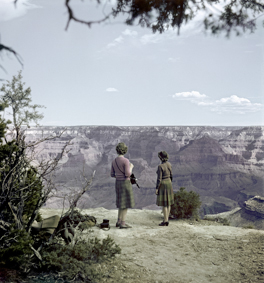 Blick in den Grand Canyon, vorne zwei Touristinnen mit Fotoausrüstung