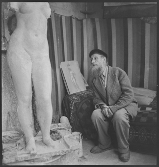 Aristide Maillol in seinem Atelier neben einer Frauenplastik