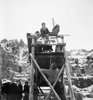 Holzturm mit Anzeigetafeln der Sprungweite an Skispringen