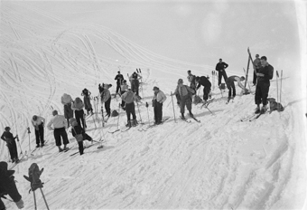 Eine Gruppe von Skifahrerinnen und Skifahrern macht sich parat für die Abfahrt